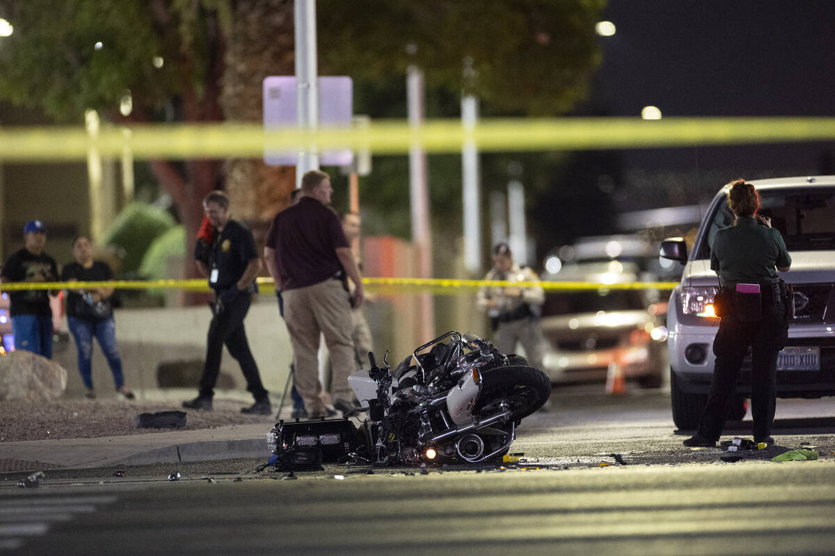 Las Vegas police investigate the scene of an accident involving a police motorcycle officer at ...