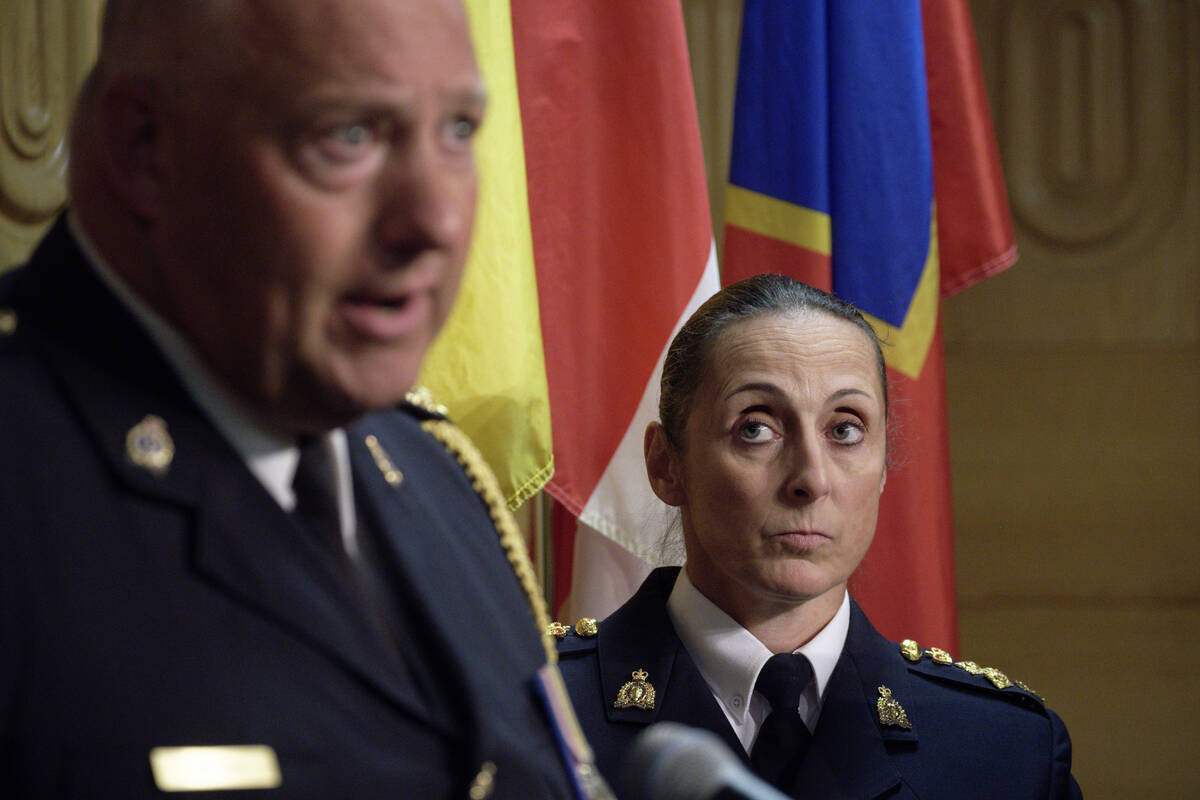 Assistant Commissioner Rhonda Blackmore, right, looks on while Regina Police Chief Evan Bray, l ...