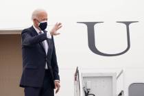 FILE - President Joe Biden waves from the top of the steps of Air Force One at Andrews Air Forc ...