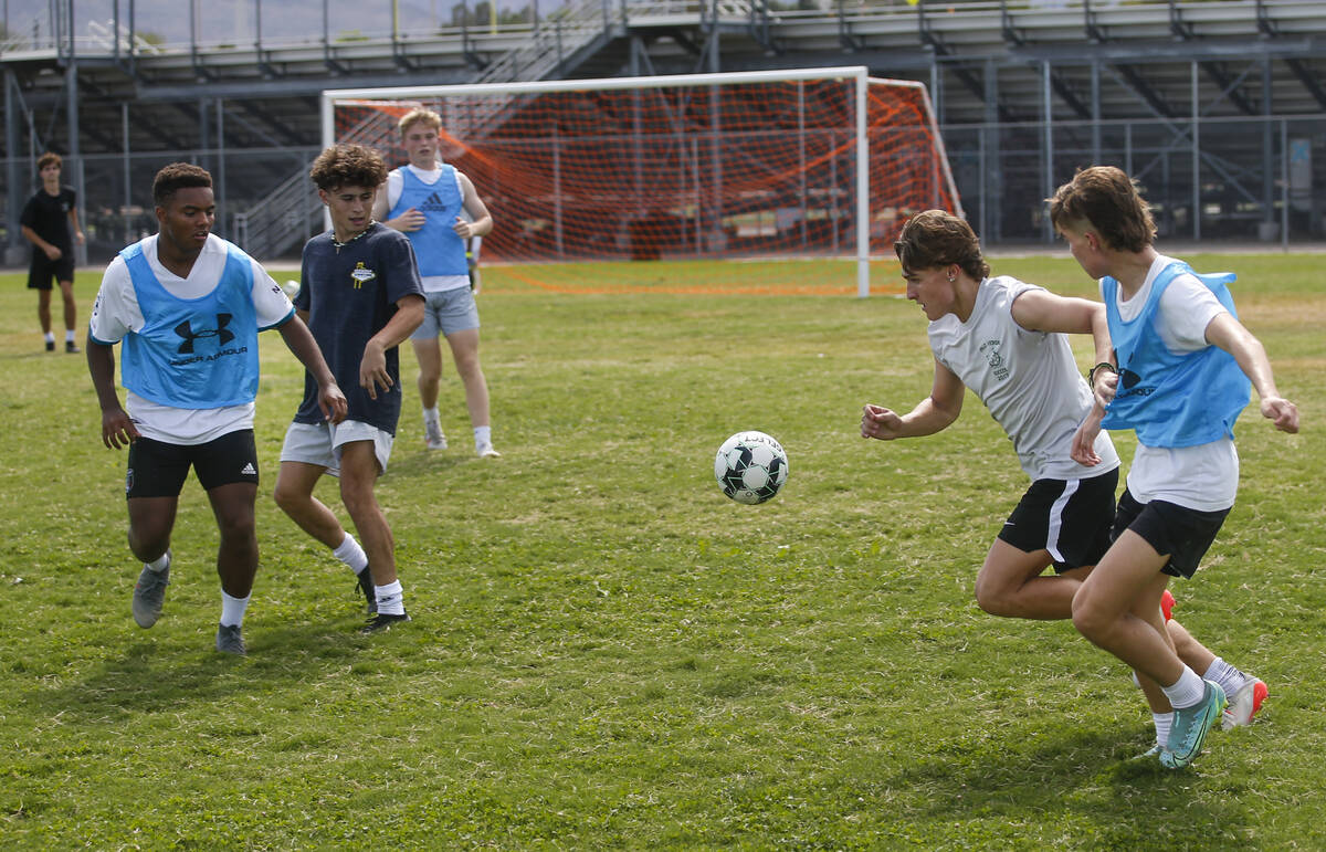 Palo Verde’s Matthew Vogel, second from right, chases after the ball in front of Dominic ...