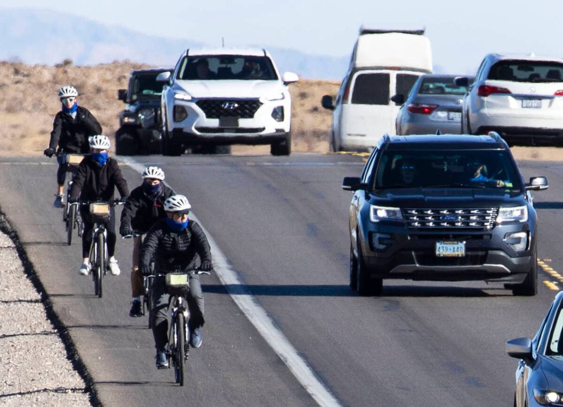 Cyclists ride their bike along the Charleston Blvd near Red Rock, on Tuesday, Dec. 29, 2020, in ...