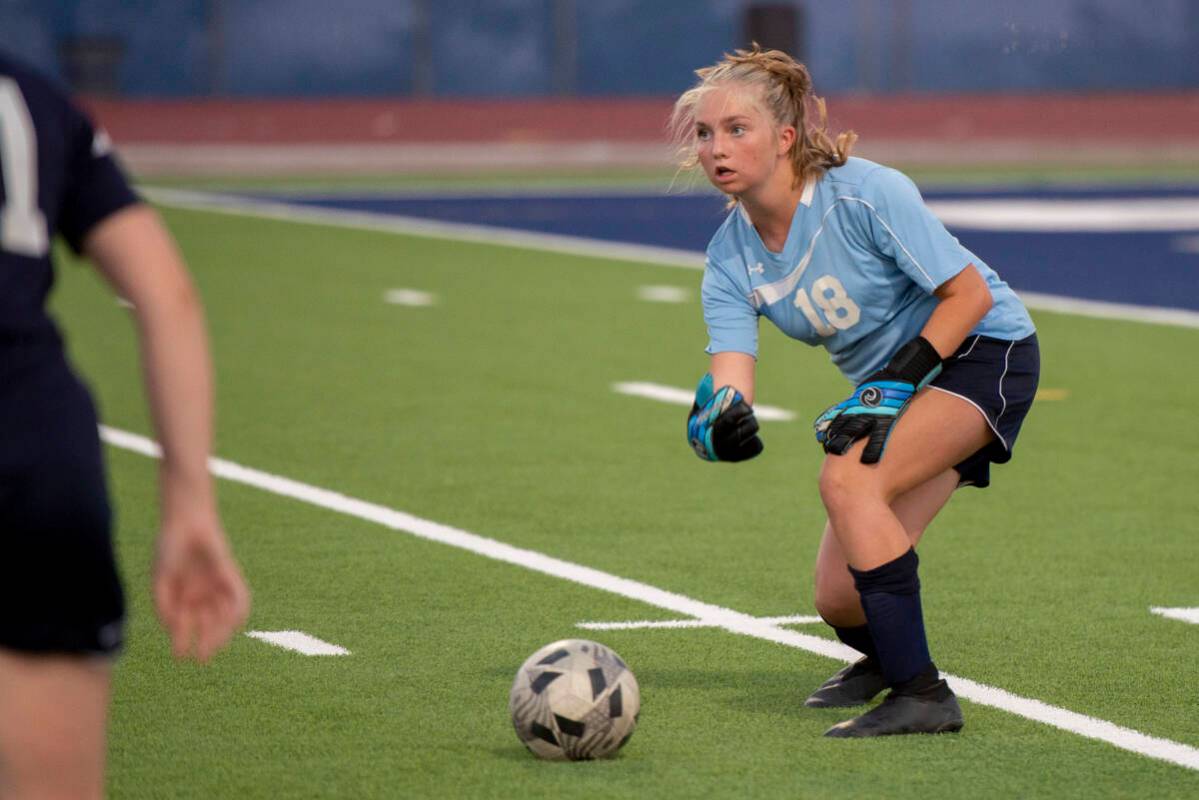 Centennial High School goalie Ellie Church (18) plays the ball to a teammate during their game ...
