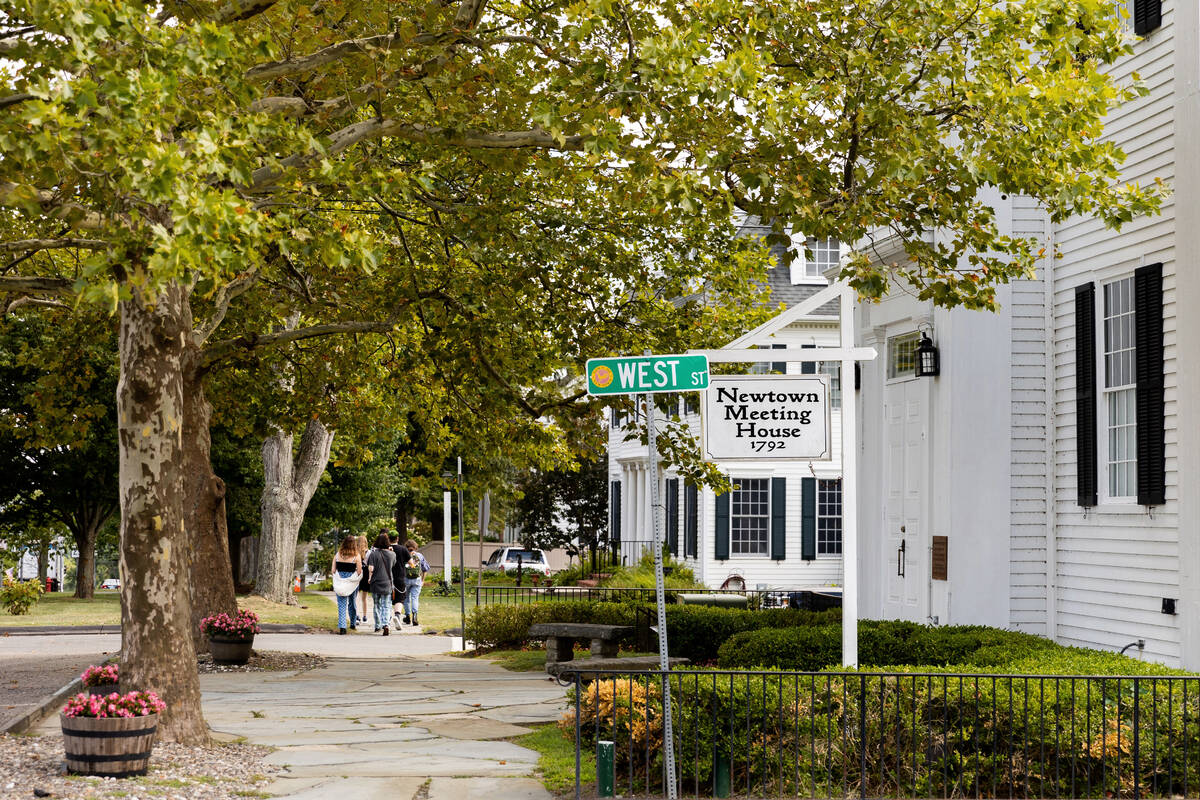 A group of teenagers walks through Newtown, Conn., Thursday, Aug. 18, 2022. (AP Photo/Julia Nik ...