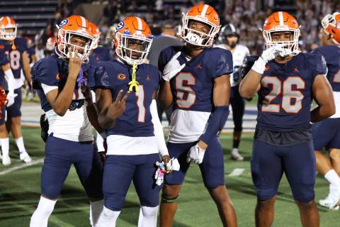 Bishop Gorman players pose following their win over Corner Canyon 42-7 during a football game a ...