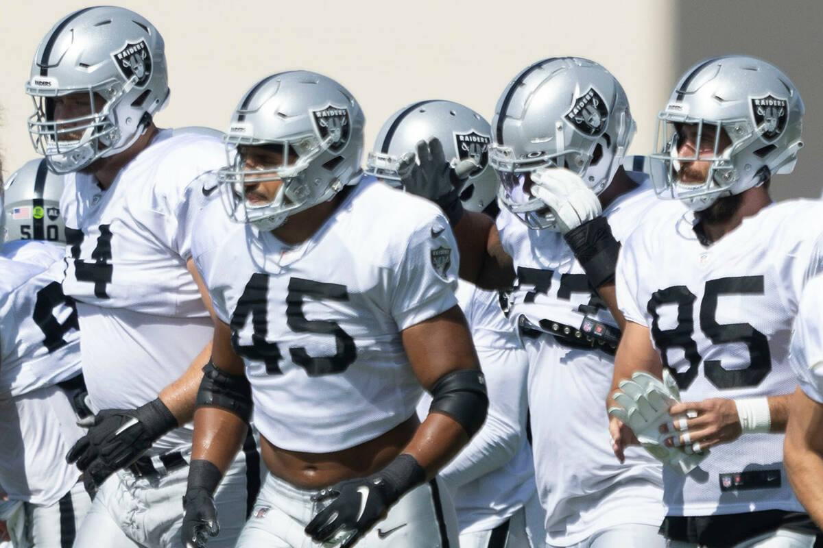 Raiders fullback Jakob Johnson (45) heads to positional drills after a team huddle during pract ...