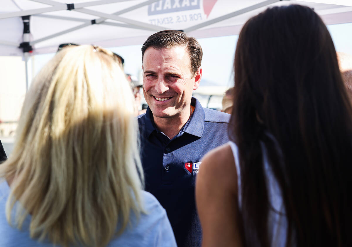 U.S. Senate candidate Adam Laxalt greets supporters prior to a panel discussing energy policy o ...