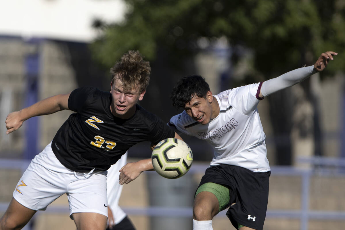 Durango’s Nicholas Lortz (33) collides with Cimarron-Memorial’s George Ruiz, righ ...