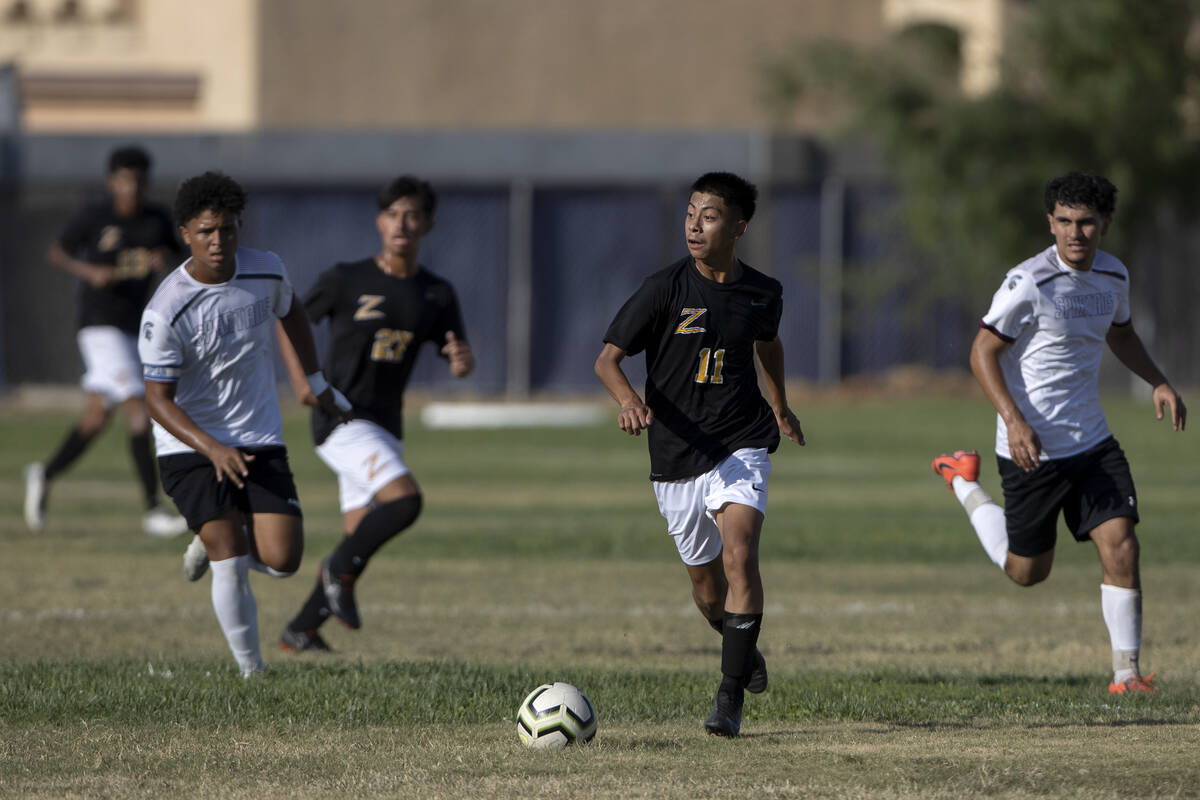 Durango’s Anthony Lopez-Tzunum (11) breaks away with the ball followed by Cimarron-Memor ...