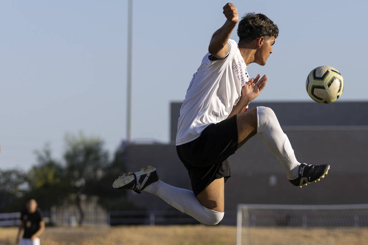 Cimarron-Memorial’s Nain Navarro (11) jumps to kick during a high school soccer game aga ...