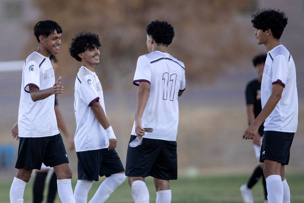 Cimarron-Memorial players celebrate after winning a high school soccer game against Durango at ...
