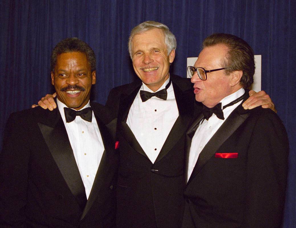 FILE - Ted Turner is joined by newsman Bernard Shaw, left, and Larry King, right, at a receptio ...