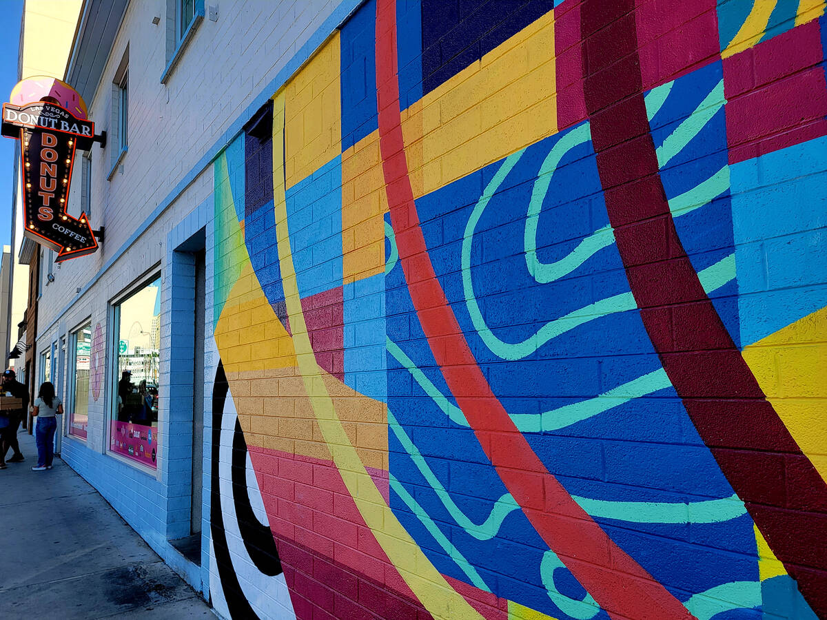 The bright colors and lively lines of Las Vegas artist Eric Vozzola's mural help draw downtown ...