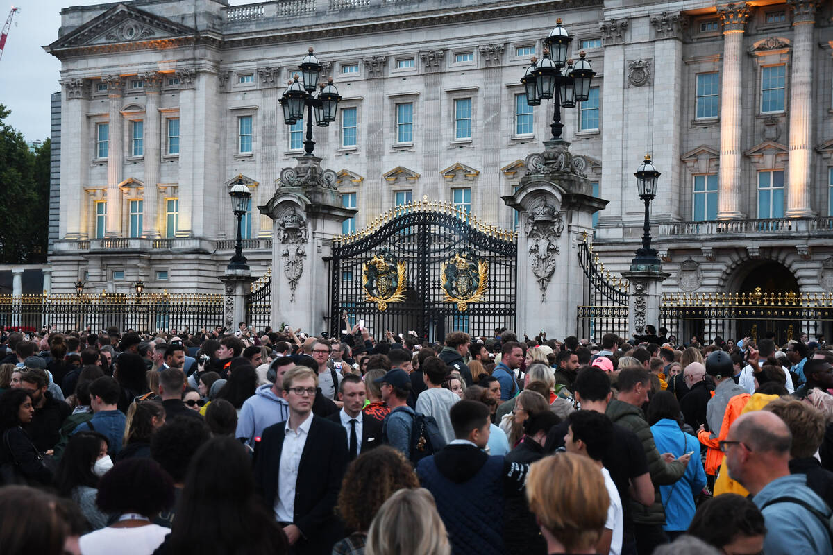 Mourners gather outside Buckingham Palace to pay their respects to Queen Elizabeth II, who died ...