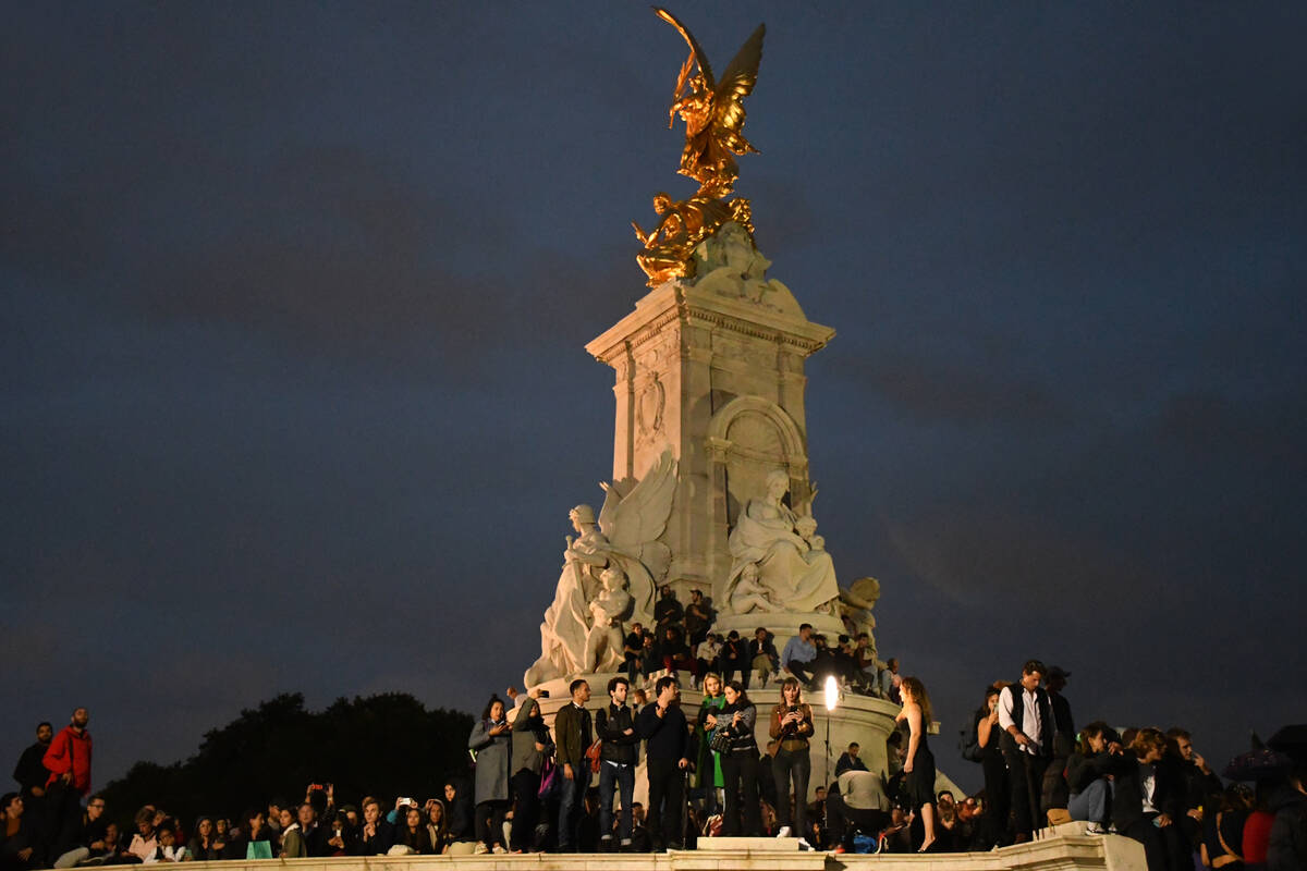 Dozens climbed onto the Victoria Memorial, the massive, gilded bronze-topped monument in front ...