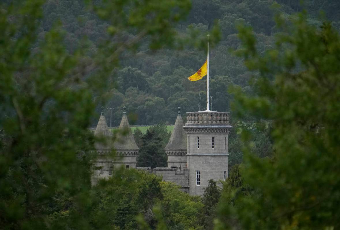 A flag flaps in the wind at half staff on Balmoral Castle in Aberdeenshire, Scotland, Friday, S ...