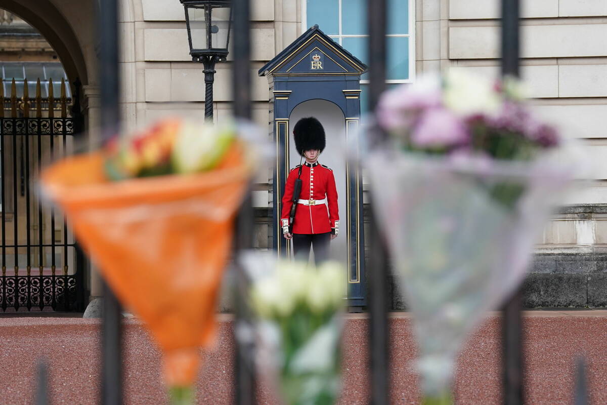 Boquet's of flowers are left on the gate at Buckingham Palace, London, following the death of Q ...