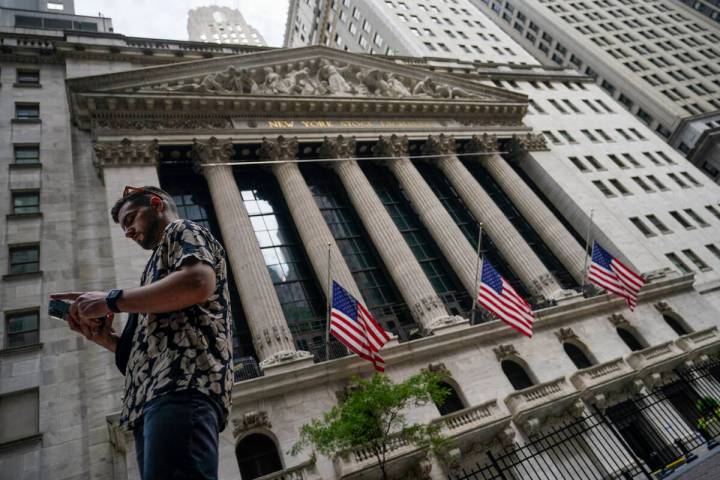 FILE - Pedestrians walk past the New York Stock Exchange, on July 8, 2022, in New York. Stocks ...