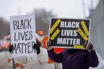 Demonstrators hold "Black Lives Matter" signs in front of the US District Court in St ...