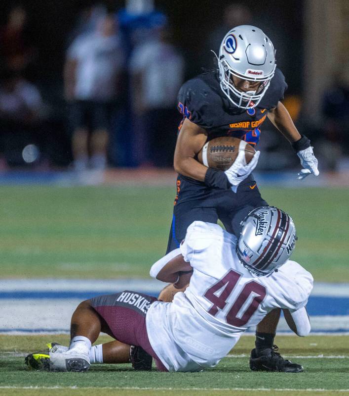 Bishop Gorman running back Myles Norman (34) looks down to Hamilton safety Kadin Roberts (40) o ...