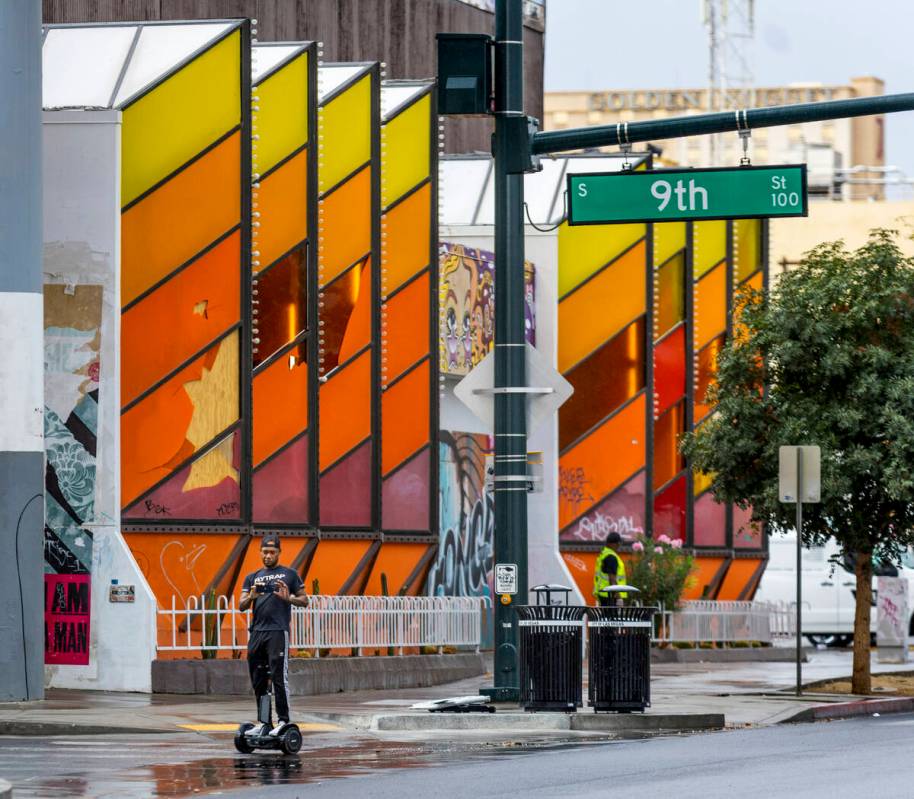 A man cruises along East Fremont Street on a rainy day in Downtown on Saturday, Sept. 10, 2022, ...