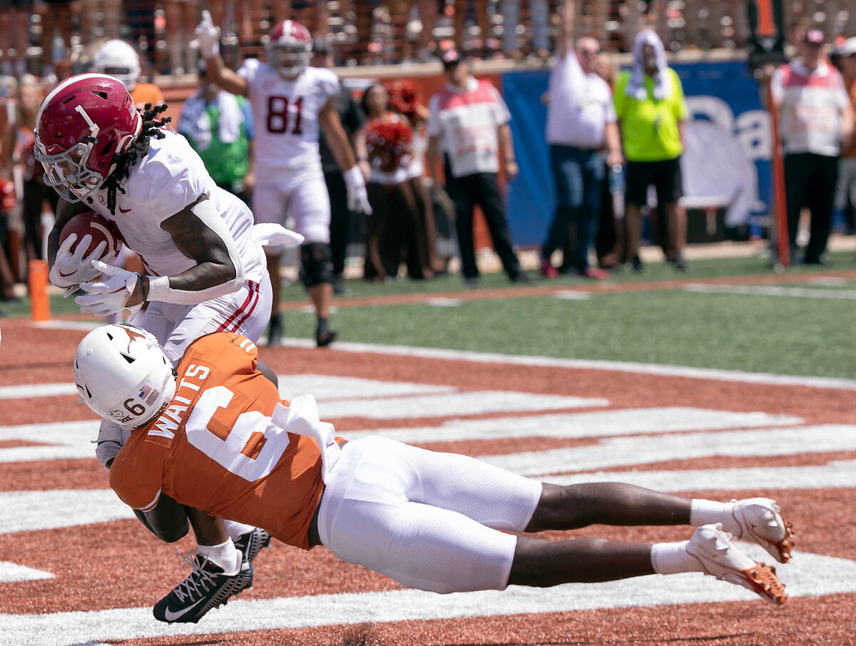Alabama running back Jahmyr Gibbs catches a touch down reception as Texas defensive back Ryan W ...