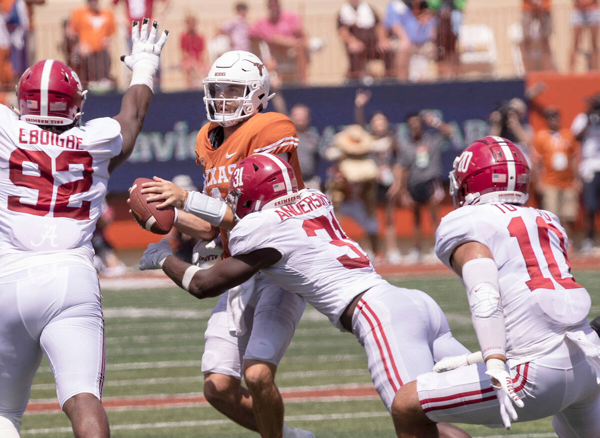 Texas quarterback Hudson Card (1) is sacked by Alabama linebacker Will Anderson Jr. (31) as Jus ...