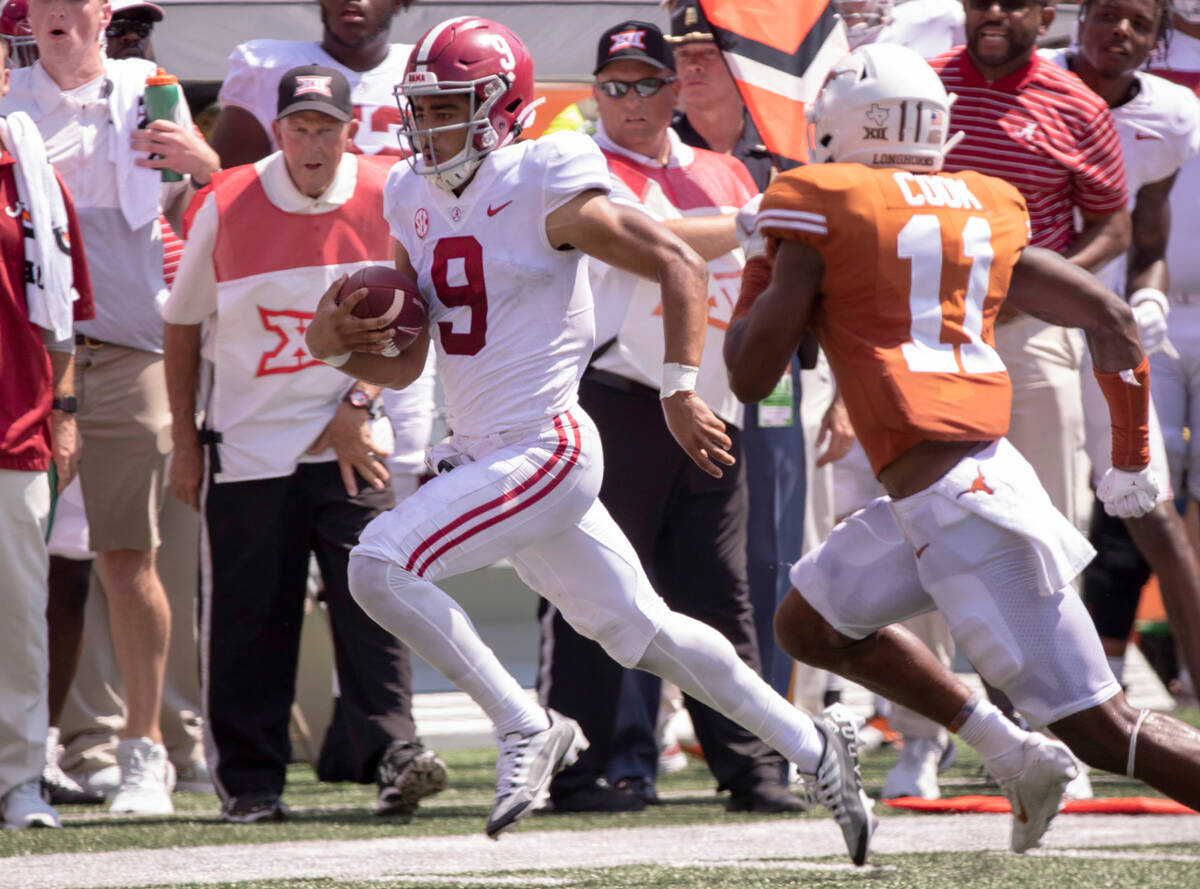 Alabama quarterback Bryce Young (9) is chased out of bounds by Texas defensive back Anthony Coo ...