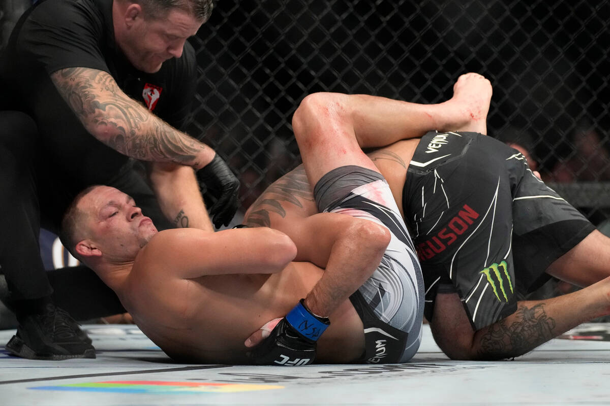 Nate Diaz, left, reacts after defeating Tony Ferguson in a welterweight bout during the UFC 279 ...