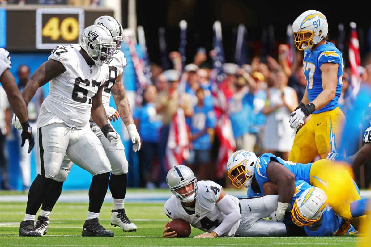 Raiders quarterback Derek Carr (4) is sacked by Los Angeles Chargers defensive tackle Sebastian ...