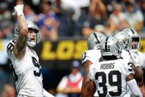 Raiders defensive end Maxx Crosby (98) gestures to the crowd during the first half of a NFL foo ...