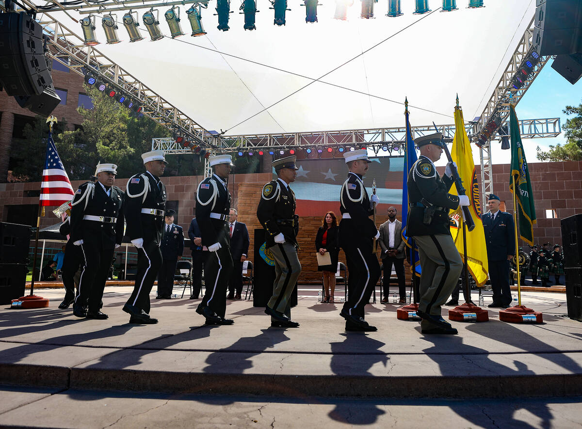 Members of the Southern Nevada multi-agency honor guard approach the stage to retrieve flags at ...