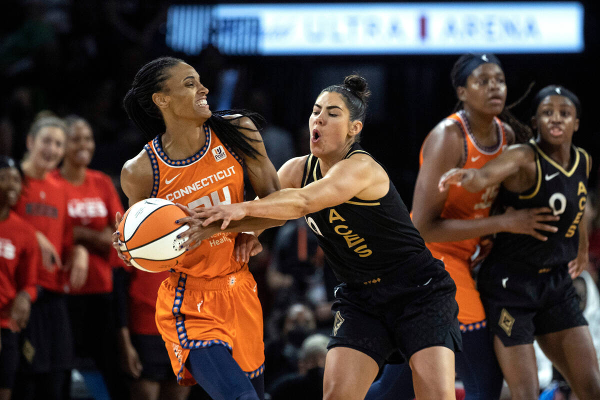 Las Vegas Aces guard Kelsey Plum (10) reaches for the ball while Connecticut Sun forward DeWann ...