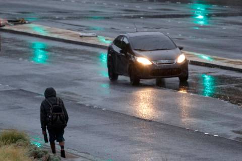 A pedestrian walks in the rain, Monday, Sept. 12, 2022, in Las Vegas. (Chitose Suzuki/Las Vegas ...