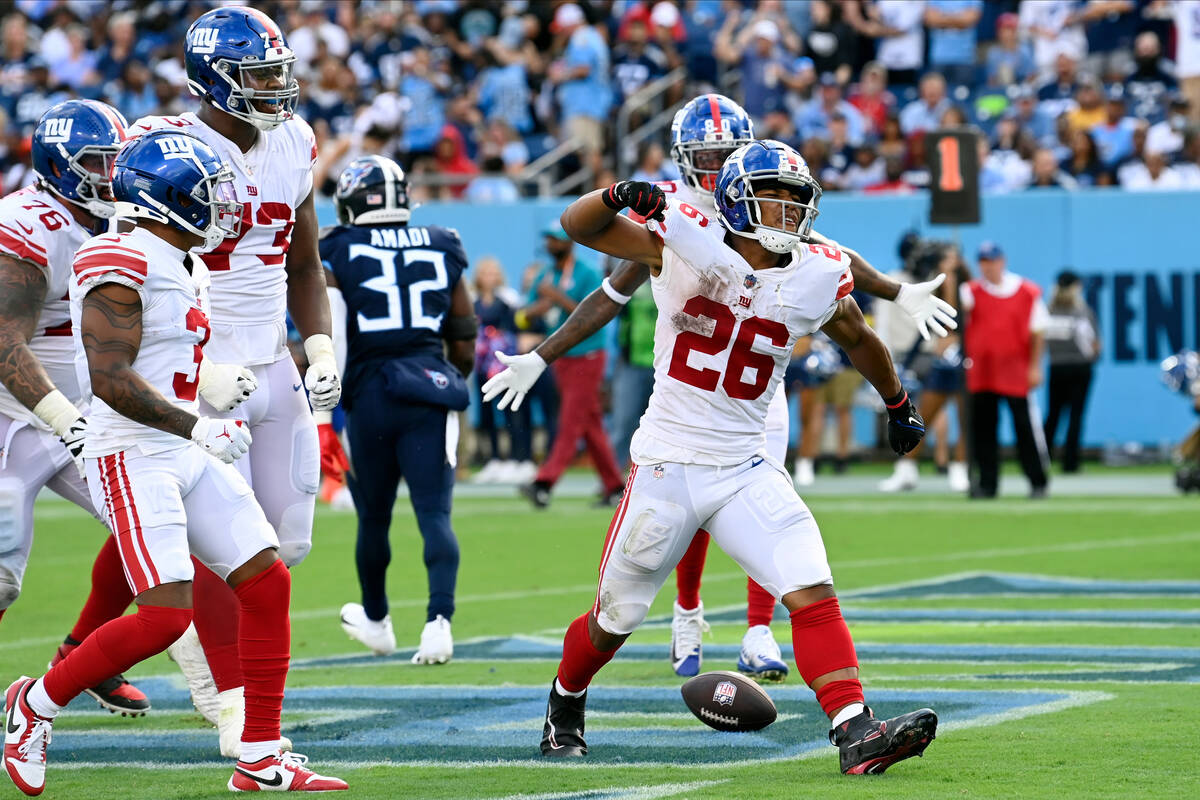 New York Giants running back Saquon Barkley (26) celebrates after making a touchdown run agains ...