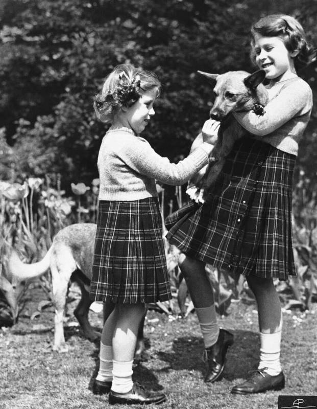 FILE - In this July 5, 1936 file photo, Britain's Princess Elizabeth, right, holds a Pembrokesh ...