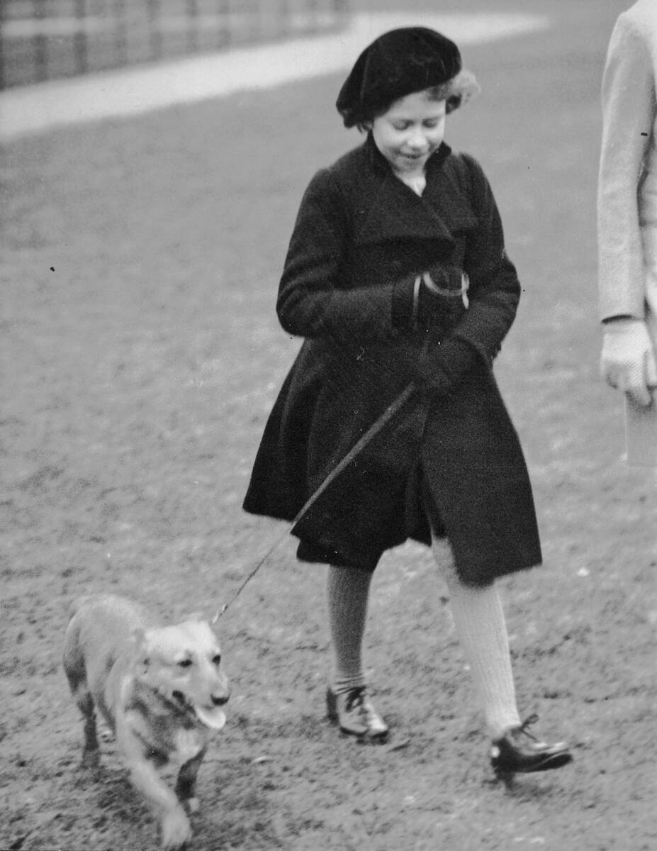 FILE - Princess Elizabeth takes her pet dog for a walk in Hyde Park, London, on Feb. 26. 1936. ...
