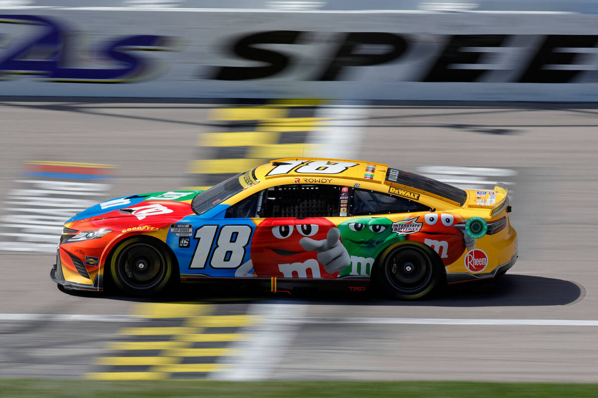 Kyle Busch crosses the start/finish line during a NASCAR Cup Series auto race at Kansas Speedwa ...