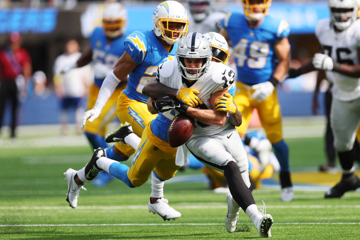 Los Angeles Chargers safety Nasir Adderley (24) forces Raiders wide receiver Hunter Renfrow (13 ...