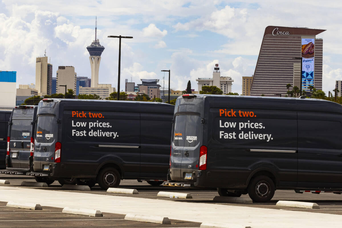 Amazon delivery vans are parked outside of  an Amazon warehouse at 650 E. Owens Ave., on T ...