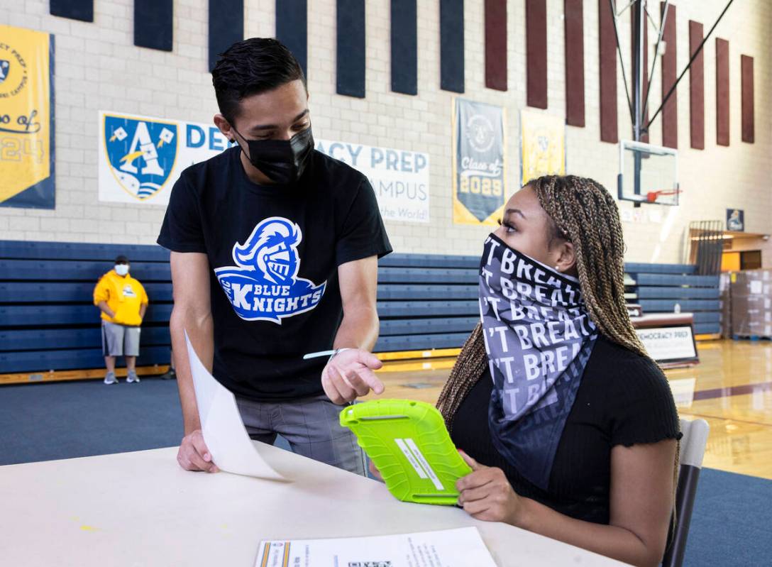 Oracio Garcia, left, a senior at Democracy Prep, helps Zuriah Barlow pre register to vote durin ...