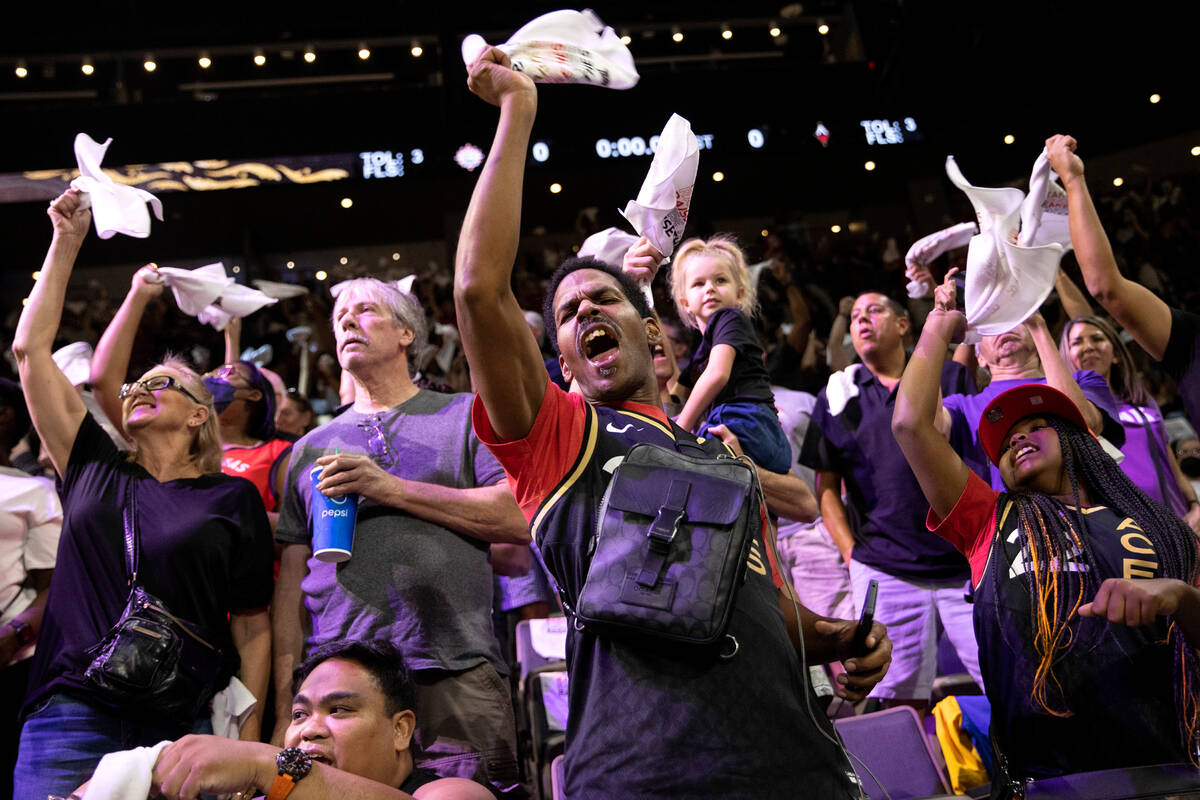 Las Vegas Aces fans erupt in cheers for their team during the first half in Game 2 of a WNBA ba ...