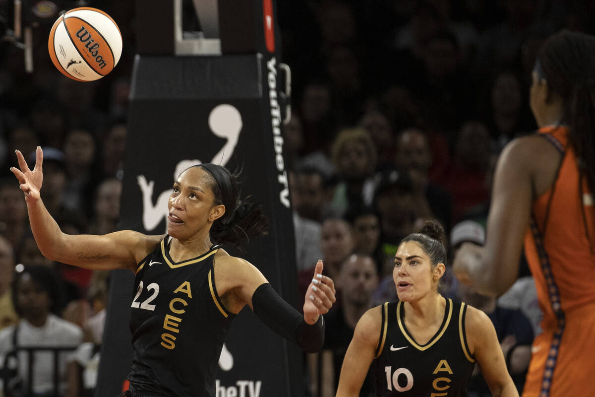 Las Vegas Aces forward A'ja Wilson (22) pivots for the rebound while guard Kelsey Plum (10) and ...