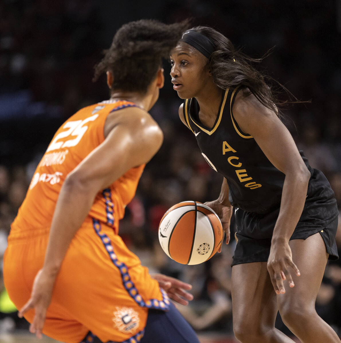 Las Vegas Aces guard Jackie Young (0) looks for an opening while Connecticut Sun forward Alyssa ...