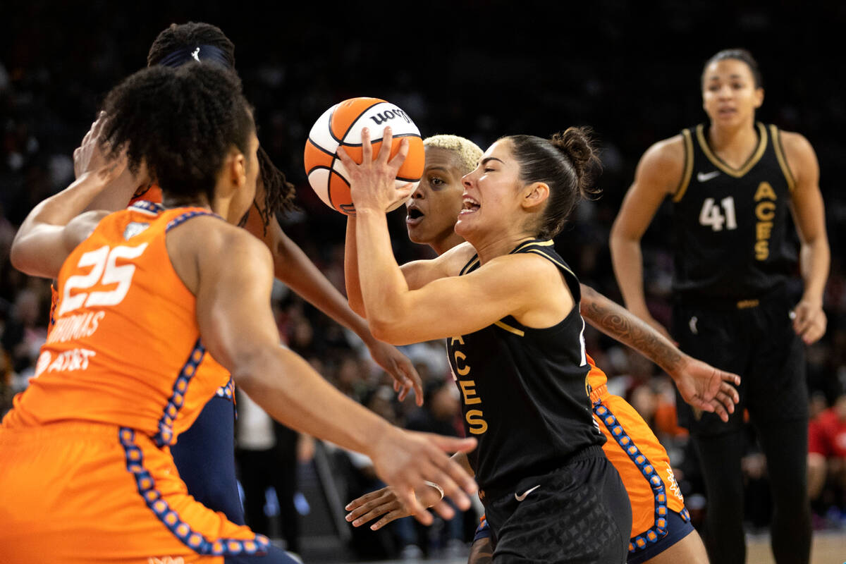 Las Vegas Aces guard Kelsey Plum (10) drives to shoot through Connecticut Sun forward Alyssa Th ...