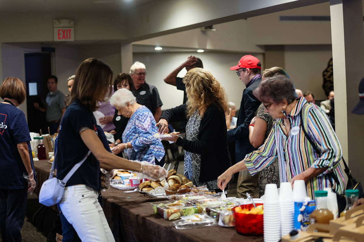 Guests pick up food at a breakfast town hall in support of Sheriff Joe Lombardo for governor at ...