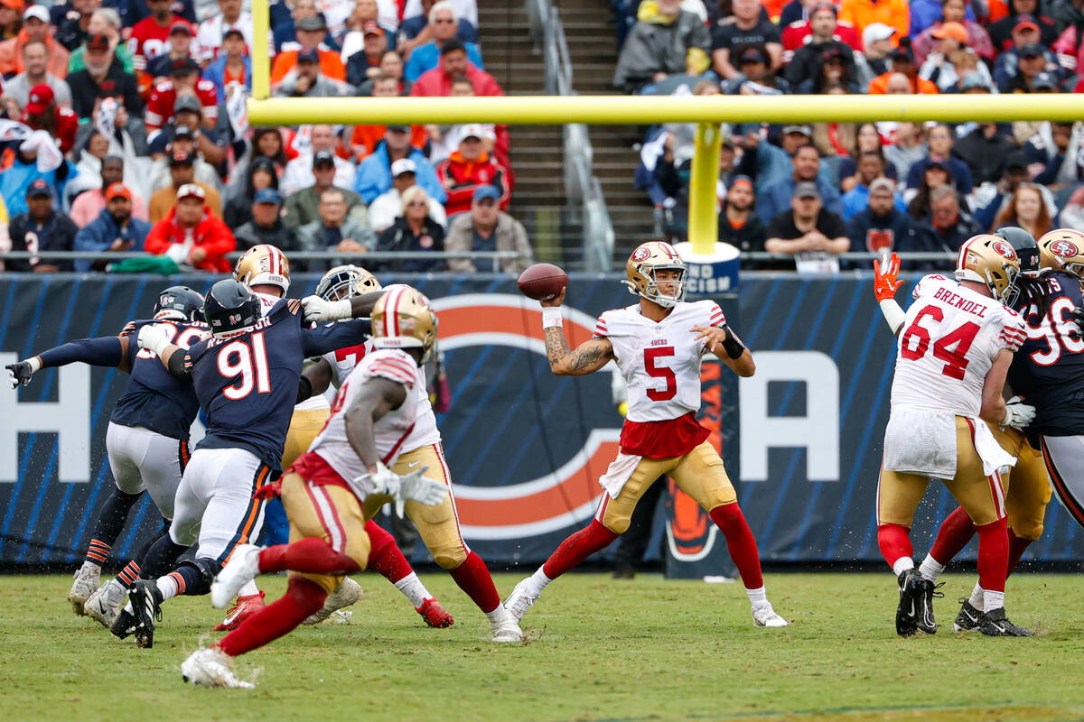 San Francisco 49ers quarterback Trey Lance (5) looks to pass the ball during the first half of ...
