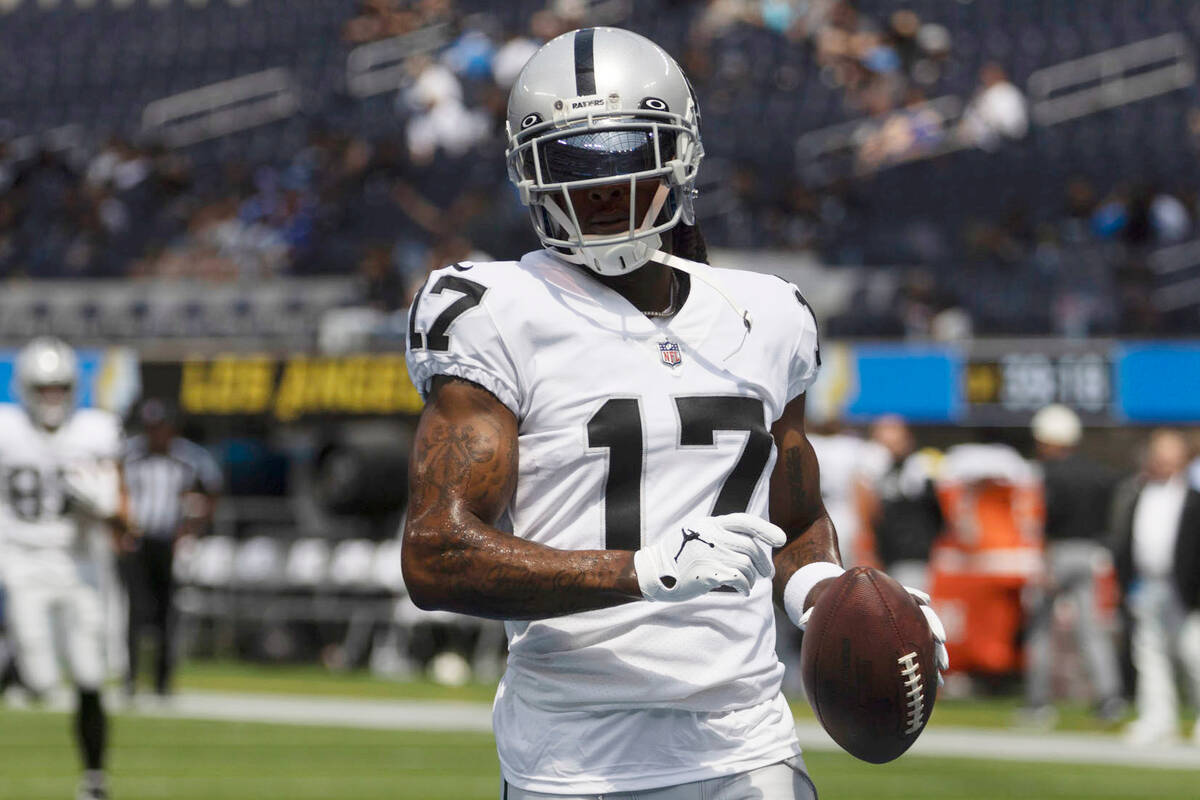 Raiders wide receiver Davante Adams (17) makes a catch before an NFL game against the Los Angel ...