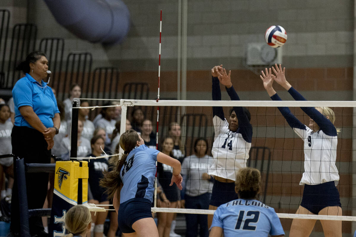 Shadow Ridge's Jyniah Sanders (14) and Lexi Luszeck (9) try to block a Foothill hit during thei ...