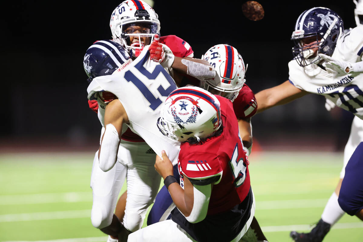 Liberty's Emarion Jones (51) tackles Kamehameha Kapalama's Sunrise Solatorio (15) in the first ...