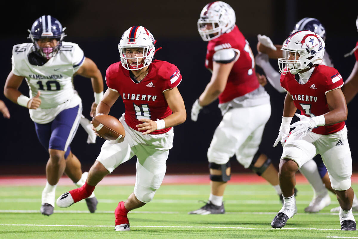 Liberty's Colin Gregorio (4) runs the ball in the first half of a football game against Kameham ...